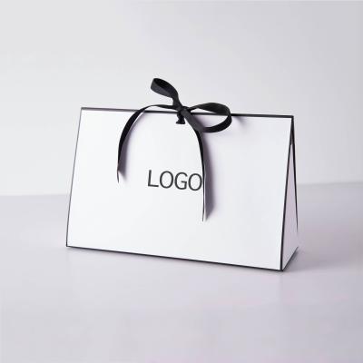 China Custom Logo Luxury Shopping Bags Gift Cardboard Paper Packaging Bag With Ribbon Bow for sale