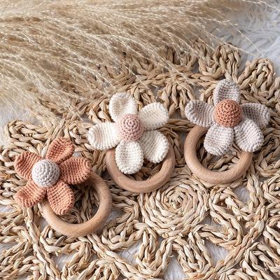 China Soft INS Hot Selling Ready To Ship Natural Handmade Knitting Wooden Crochet Baby Daisy Flower Wrist Teether Ratchet Toy for sale