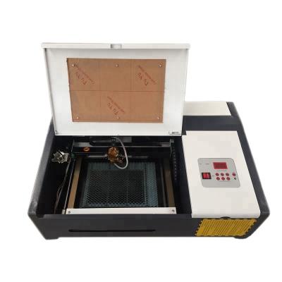 China Laser Engraving Mini CO2 Coconut Shell Laser Cutting and Engraving Machine 3020 for sale