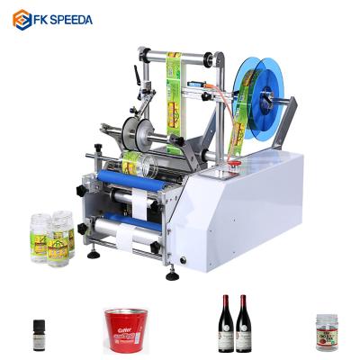 China Wine beer round bottle placing labeling machine FK-SPEEDA wholesale price semi-automatic round sticker applicator label bottle candle labeling machines for sale