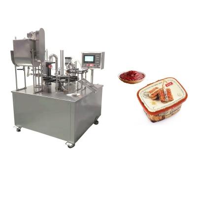 China Rotary type chili sauce cups food sealer/small tray peanut butter filling sealing machine/sesame paste cup packing machine for sale