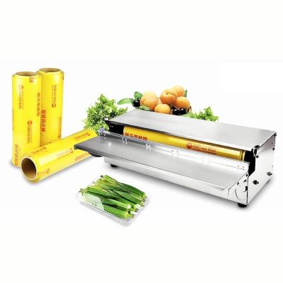 China Manual Food Tray Cling Film Wrapping Machine of Food Supermarket for Fruits and Vegetables for sale