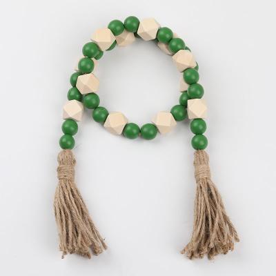 China Art Deco Fashion Green and Natural Wooden Bead Garland Handmade Cotton Tassels Wooden Beaded String Home Decor for sale