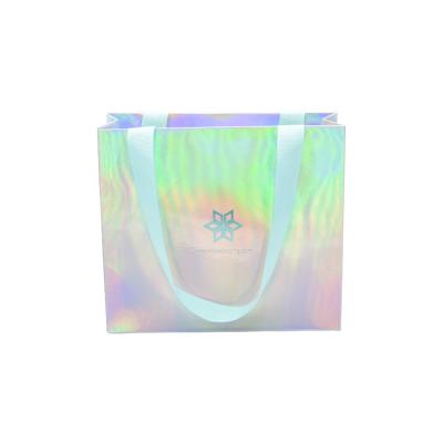 China Dongguan Recyclable Custom Cosmetics Ribbon Silk Handle Luxury Gift Packaging Holographic Paper Bags With Your Own Logo Printed for sale