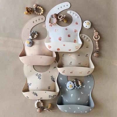 China BPA Free Customized Printed Logo Multi Colored Soft Silicone Easy To Clean Waterproof Baby Bibs With Crumb Catcher for sale