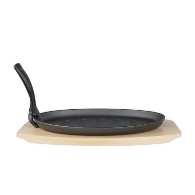 China Durable Oval Cast Iron Sizzling Pan Cast Iron Sizzling Serving Pan With Wooden Base Tray for sale