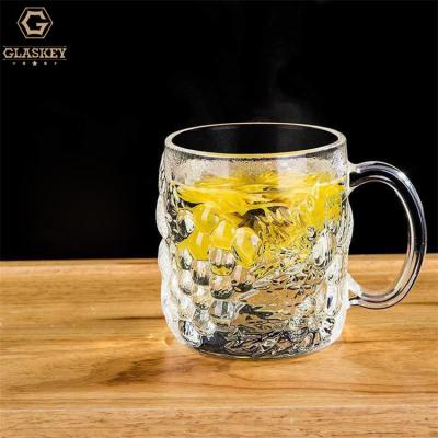 China Sustainable Heat Resistant Tea Mug With Handle Glass Embossed Grape Etched Draft Beer Mug Thick Wine Glass for sale