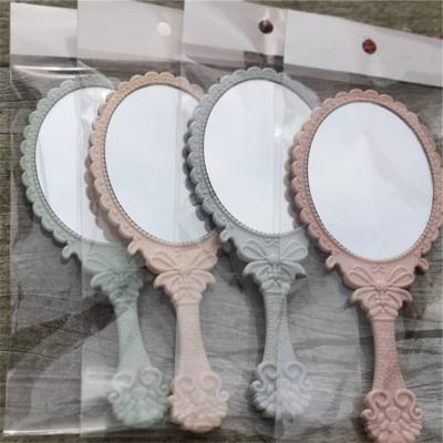 China Personalized Creative Handheld Cosmetic Mirror Small Glass Mirror Plastic Portable Gift for sale