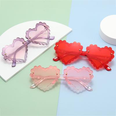 China Fashion New Design PC Heart Shape Kids Sunglasses Rimless UV400 Eye Protection for sale