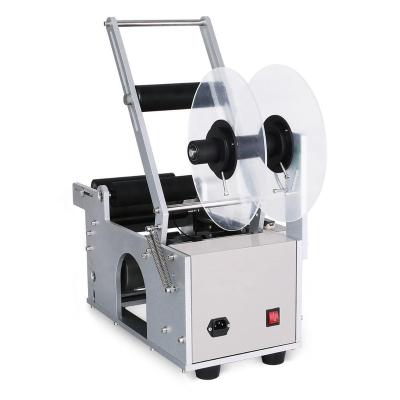 China Tabletop Food Manual Small Bottle Labeling Machine Price for sale