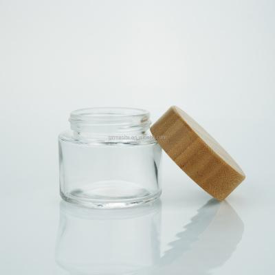 China 2 Ounce Wide Flower Glass Mouth Lid Wooden Child Safe Bamboo Jar Packaging Medicine Jar for sale