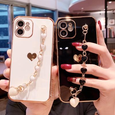 China 2021 Hot Sale Shockproof Fancy Phone Cases Lover Heart Plated Phone Cover With Hand Strap for sale