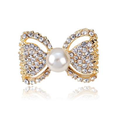 China Fashion Brooch Gold Rhinestone All-match Hollow Bow Suit Corsage Brooch Accessories For Women for sale