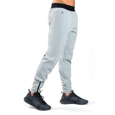 China Custom Men's Size Track Sports Pants Polyester Breathable White Fitness Tracker Shaping Elastic Pants With Zipper Pockets Bottom Zipper for sale