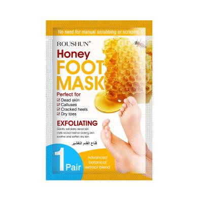 China Remove thick honey foot mask from ROUSHUN horny layers and dead epithelial cells repair rough heels exfoliating foot mask for sale