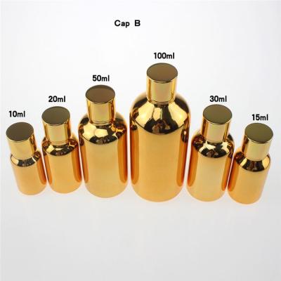 China Luxury personal care gold 50ml essential oil glass bottles with aluminum cap, wholesale empty 50ml glass container for essential oils for sale