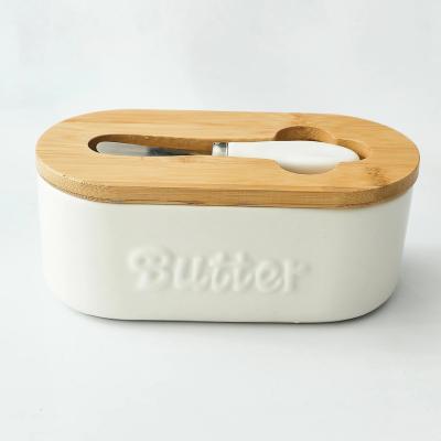 China Freshness Preservation Oval Butter Storage Container Ceramic Porcelain Sealed Butter Box With Bamboo Lid And Knife for sale