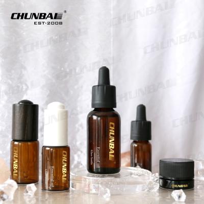 China luxurious customized amber 10ml 15ml 30ml 2oz press pump cosmetic essential oil serum glass dropper bottle with box packaging for sale