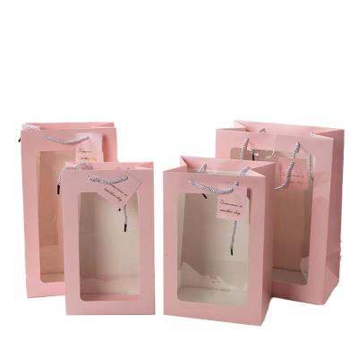 China Recycled Materials Printing Your LOGO Custom Recycled Paper Packaging Gift Bag With Clear Transparent Window for sale