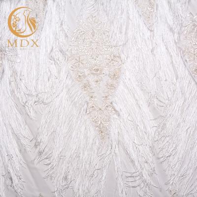 China Viable Hot Selling Bridal Net Knitting Fabric Of Wedding Dress Gown Tassel Embroidery Design for sale