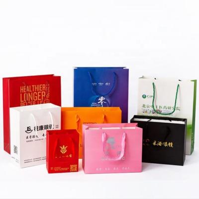 China Factory Wholesale Durable Cheap Custom Logo Printed Paper Shopping Clothing Gift Packaging Bags for sale