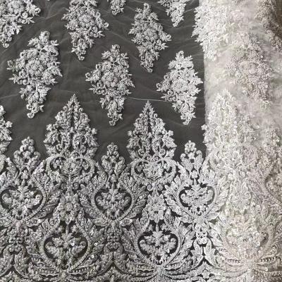 China Viable Luxury White Beaded Bridal Crystal Sequins Lace Fabric Heavy Beaded Lace Fabric For Wedding Dress for sale