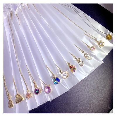 China FASHIONALLY Mixed Wholesale Light Luxury Multi Designs Shape Zircon Pearl Four Leaf Clover Flower Super Snap Butterfly Pendant Necklace for sale