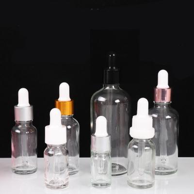 China Cheap Price Cosmetic Essential Oil Bottle Customized Clear Amber Cosmetic Glass Dropper Bottles With Cap for sale