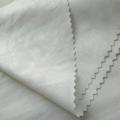 China Anti-static cheap soft 87gsm flower embossed 100% micro peach skin polyester peach fabric for home textile for sale