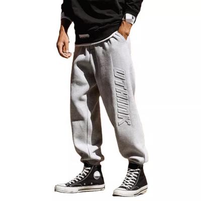 China Anti-wrinkle December OEM custom heavyweight 3d embossed logo 100% cotton fleece stacked sweatpants baggy soft sweat track jogging pants for men for sale