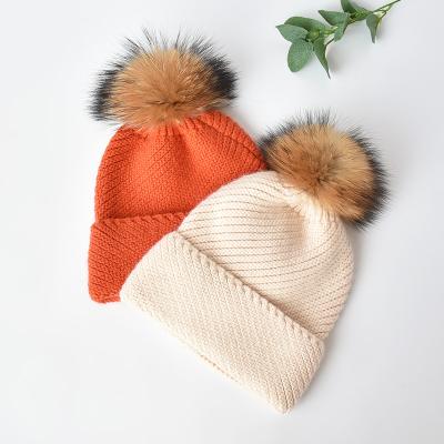 China COMMON Hotsale Winter Knitted Wide Cuff Hat With Real Fur Pompom Wool Knit Women Ski Skull Hat Beanie Warm Hat Custom Label for sale