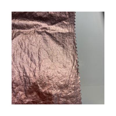 China Water Resistant Factory Price 380T Plain Weave Nylon Taffeta Foiled Gold Crepe Fabric Windproof Customized For Down Coat for sale