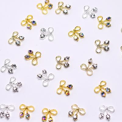 China Shiny Glitter Golden Silvery 3d Nail Art Alloy Bows Nail Art Accessories With Rhinestones Jewelry Nails Art Decoracion for sale