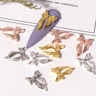 China Shiny Metal Alloy Rhinestones Bow 3D Nail Art Charms Zircon Nail Art Jewelry Decoration Alloy Bow Nail Art Designs for sale