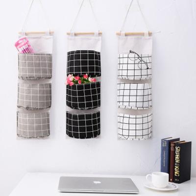 China Simple Home Sustainable Multi-Layer Wall Mounted Wardrobe Storage Bag Fabric 3 Grid Hanging Washable Fabric Storage Bag for sale