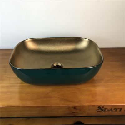 China Modern Gold Color Bathroom Ceramic Sink Table Top Luxury Gold Wash Basin Designs for sale