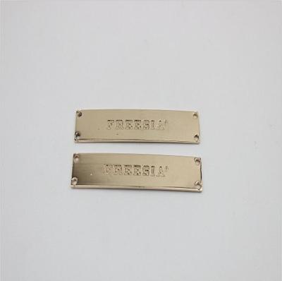 China Supply custom gold iron debossed logo metal shoe accessories metal buckles for shoelace for sale