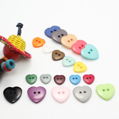 China Wholesale colorful 2 hole heart shape plastic resin button of viable high quality cheap prices for diy accessories for sale