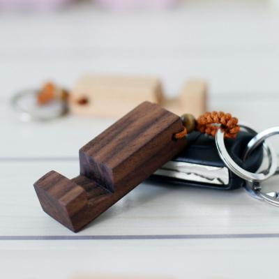 China Mini Portable Processable Custom Logo Key Chain Adjustable Portable Compact Wooden Cell Phone Stand for sale