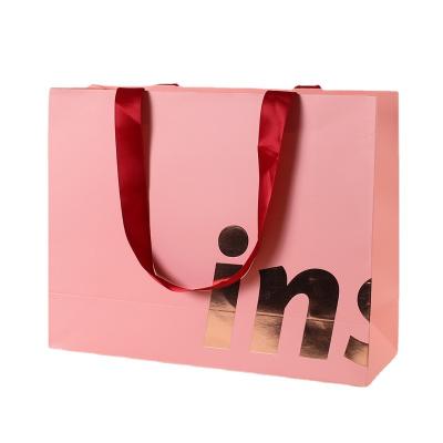 China Custom LOGO Thickened Ins Style Recyclable Clothing High End Pink Handle Shopping Bag for sale