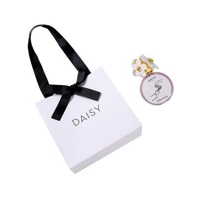 China Biodegradable Small Square Bow Kraft Paper Bow Gift Storage White Portable Ins Style Birthday Gift Bag for sale