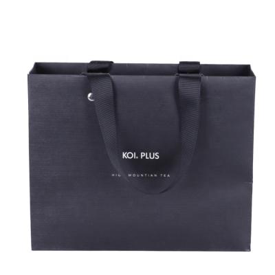 China Recyclable Custom Printed White Retail Paper Carry Bags Luxury Boutique Clothes Packaging Bags For Clothes With Your Own Logo for sale