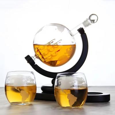 China New design pure handmade globes stand to shape wine whiskey decanter globe holder shape glass whiskey decanter for sale