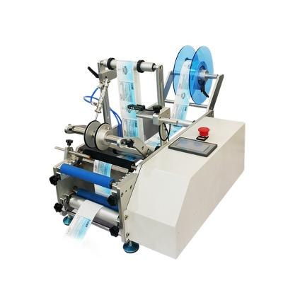 China Semi Automatic Food Wine Oval Round Adhesive Bottle Labeling And Label Applicator Machine For Round Bottle for sale