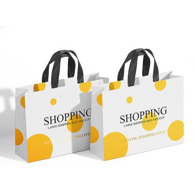 China Recycled Materials Custom Design Ribbon Handle Boutique Shopping Paper Bag For Clothes Packaging for sale