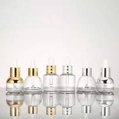 China Recyclable Custom Logo Cosmetic Packaging 35ml Clear Empty Essential Oil Glass Bottles With Dropper for sale