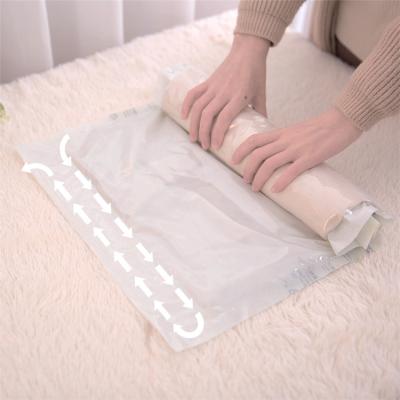 China Roll Folding Up Vacuum Space Saver Compression Storage Bag T-Shirt Travel Bags And Compression Plastic Organizer For Travel for sale