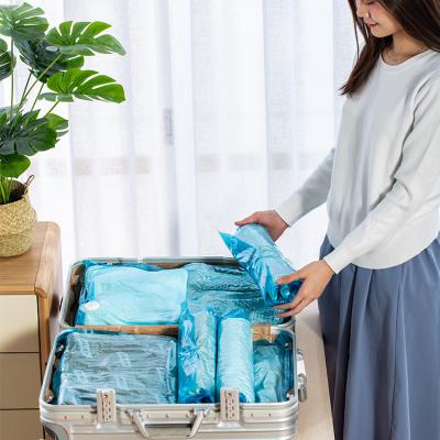 China Rolling Folding Up Space Saver Bags No Needed Pump Squeeze Organizer Clothes Duvets Bedding Towels Giant Blue for sale