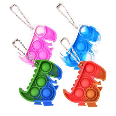 China Mini Silicone Dinosaur Jumping Bubble Push Key Chains Key Chains Wiggle Toy dinosaurio for sale