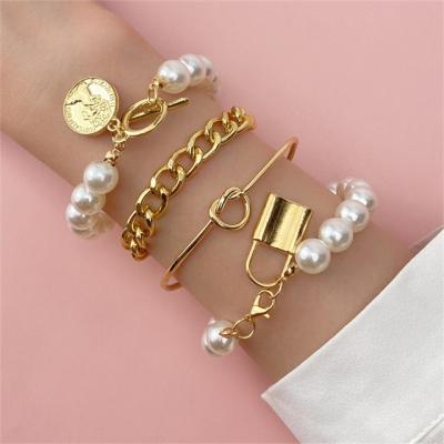 China Punk Knot Luxury Multilayer Pendant Bracelet Delicate Cion Key Pearl Gold Bangle Bracelet For Women for sale